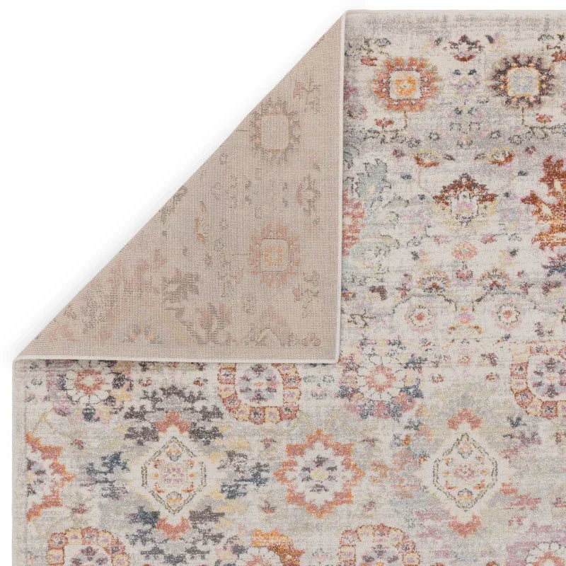 Multicolour patterned area rug with corner flipped to show backing and texture
