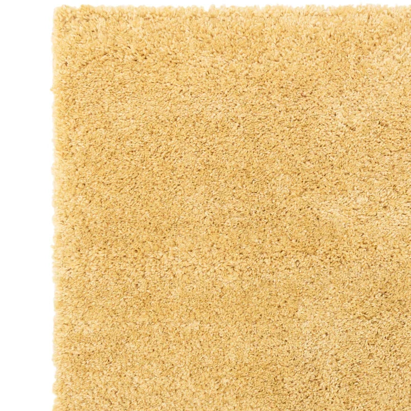 Beige shaggy rug with soft pile, corner detail showing plush carpet texture