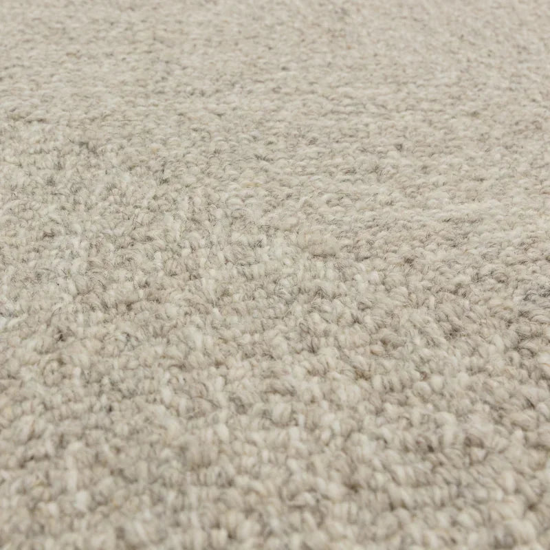 Close-up of beige loop pile carpet texture with soft wool fibres