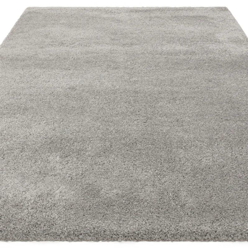 Light grey shaggy area rug with soft pile texture, shown from above at an angle