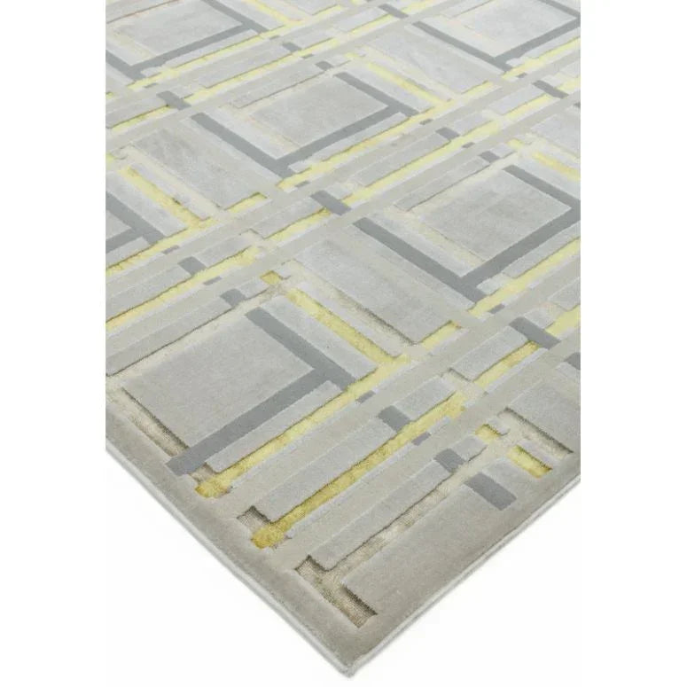 Modern geometric area rug with grey and yellow lines on a light background