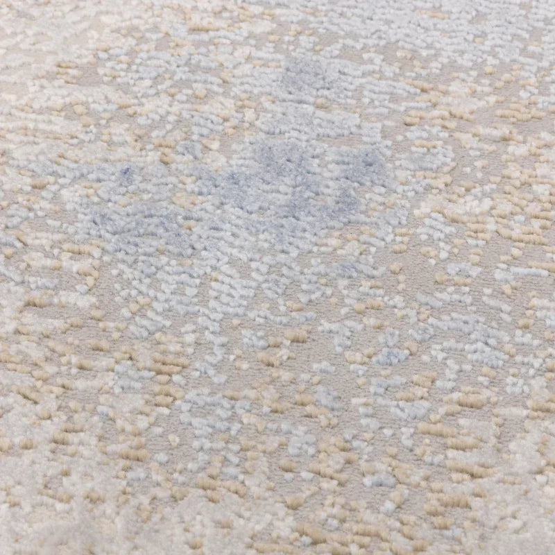 Close-up of textured beige and blue patterned rug pile