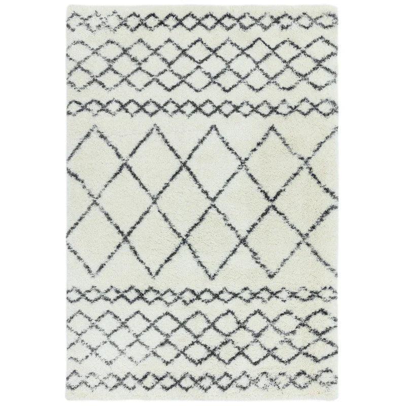 White shaggy rug with black diamond and lattice pattern, rectangular, flat lay view