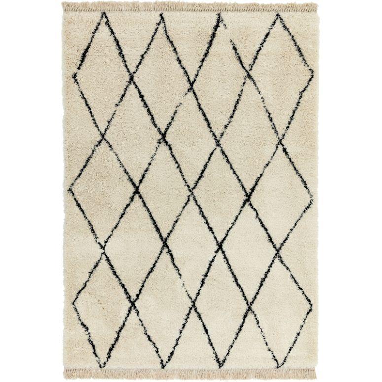 cream area rug with black diamond pattern and short fringe edge