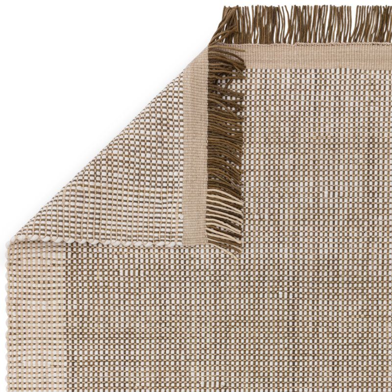 Beige woven rug with fringe corner detail and textured surface