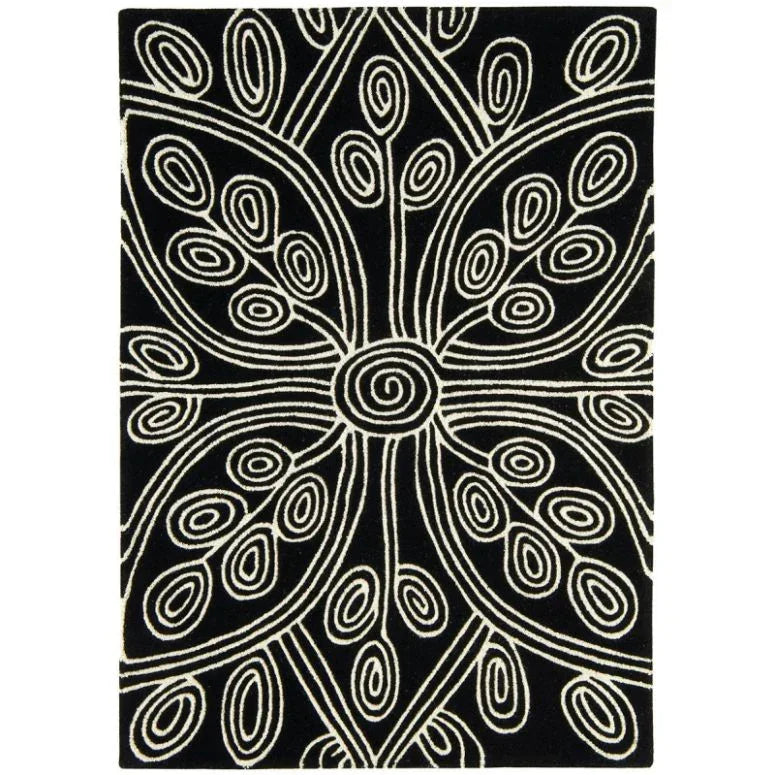 Black area rug with cream abstract swirl and leaf pattern