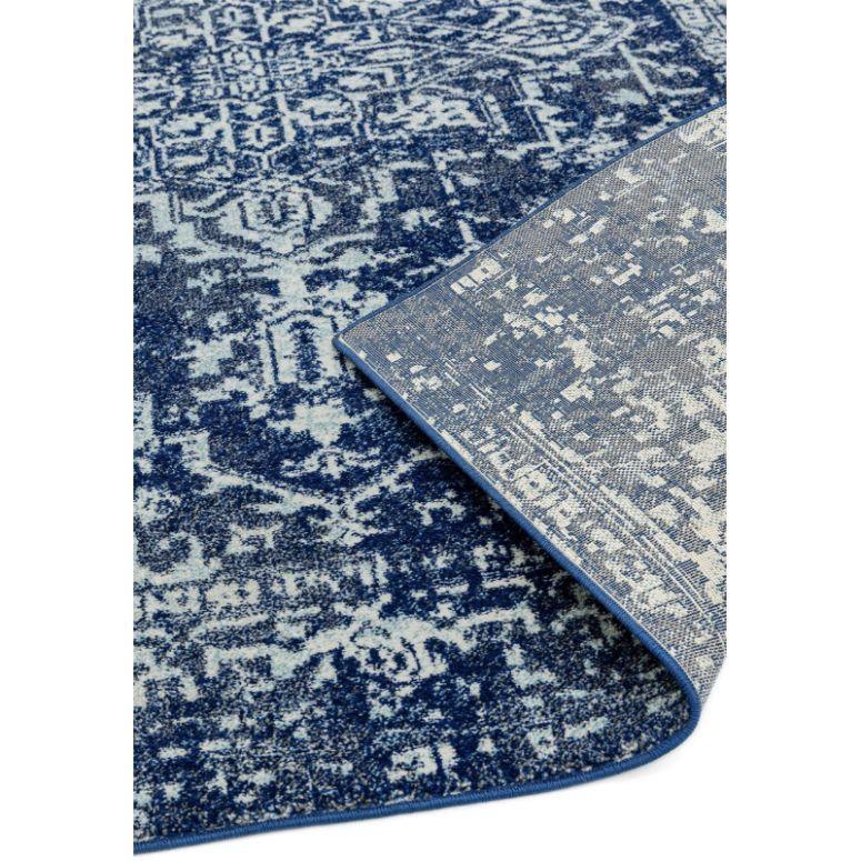 Blue patterned area rug with modern design and visible backing corner