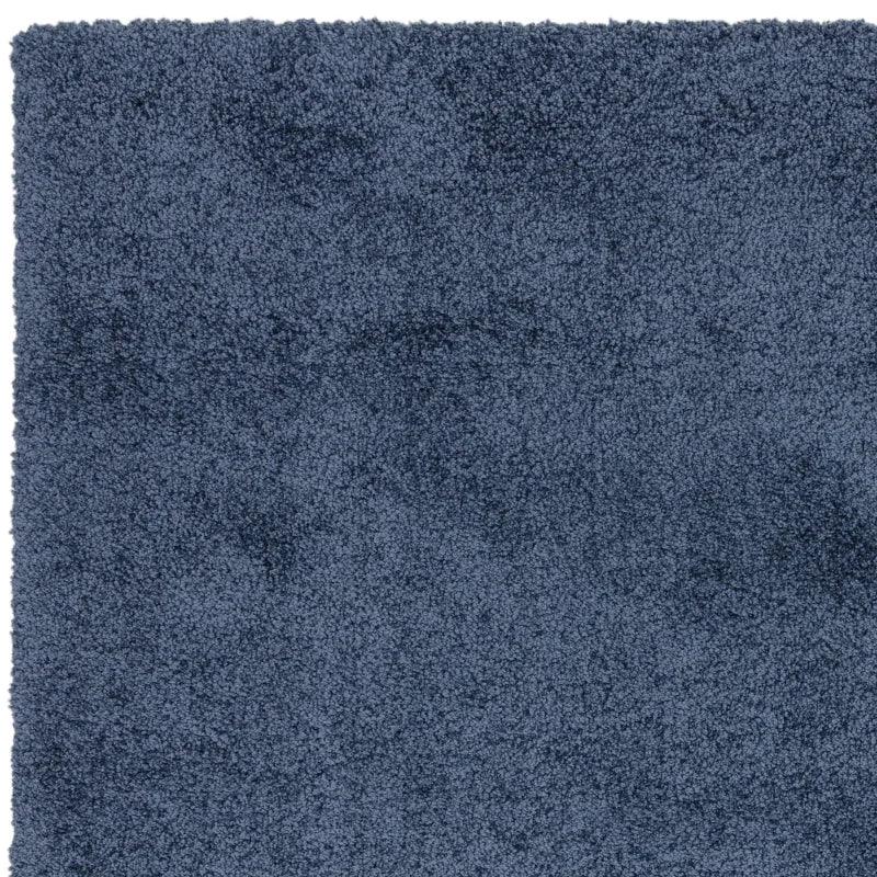 Navy blue shaggy rug close-up showing soft textured pile