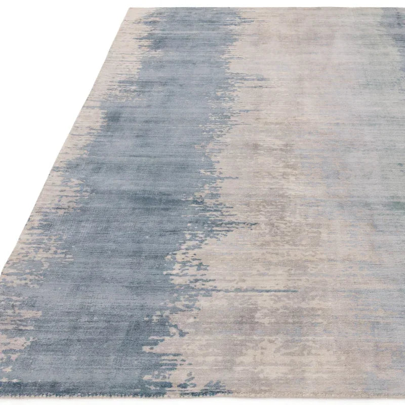 Blue and grey abstract area rug with textured pattern and soft fabric finish