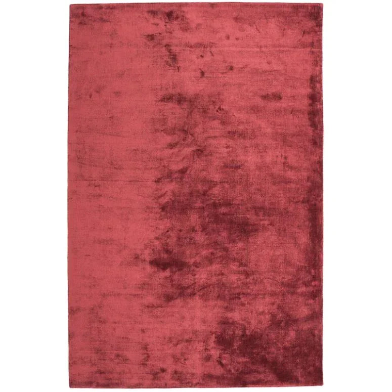 Plush red area rug with soft textured finish and rectangular shape