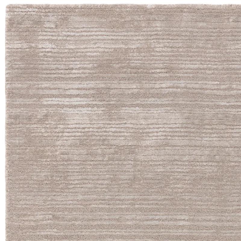 Beige textured area rug with horizontal stripe pattern, close-up view of material