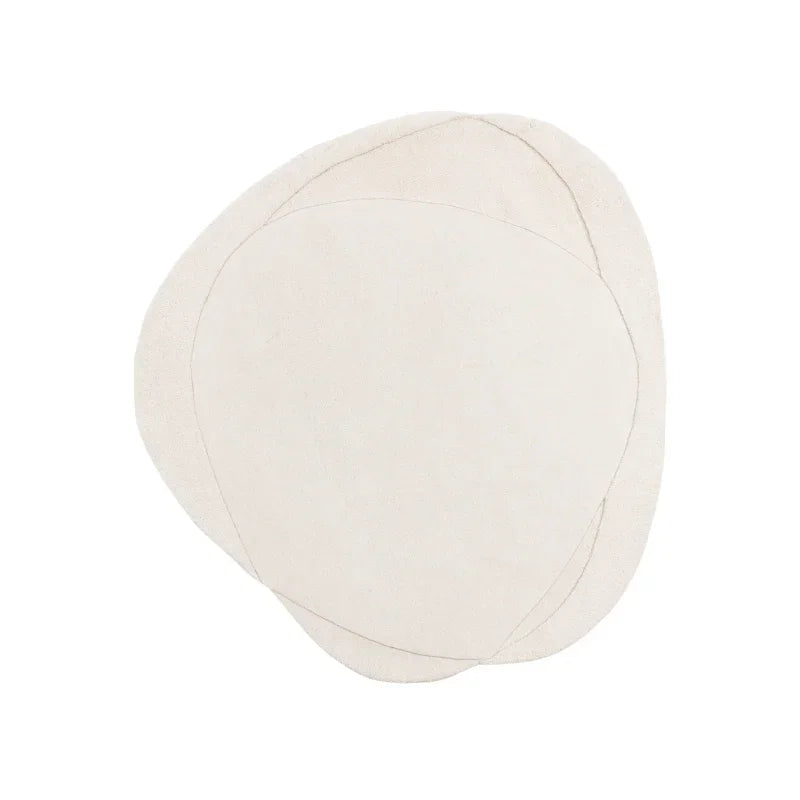 Abstract cream area rug with overlapping organic shapes on white background