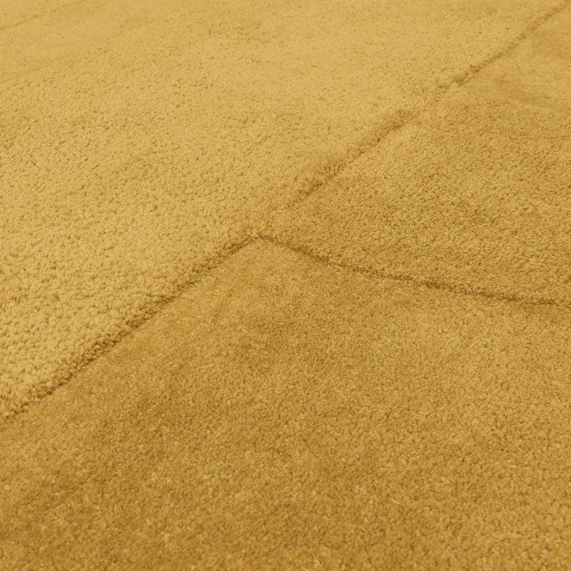 Close view of beige textured area rug with soft pile and grid pattern detail