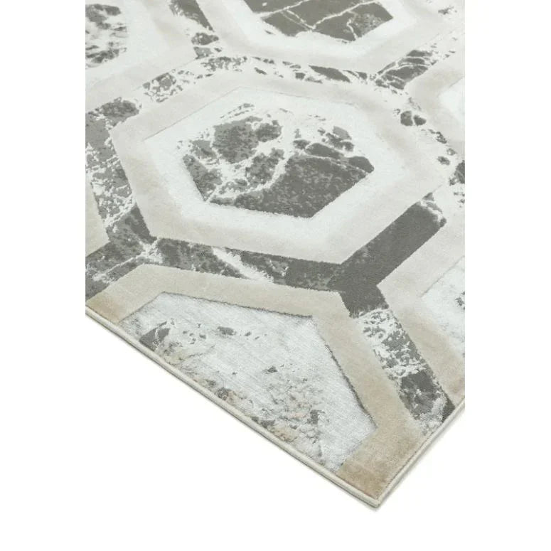 Grey geometric pattern rug with marble effect detail and beige borders, angled corner view
