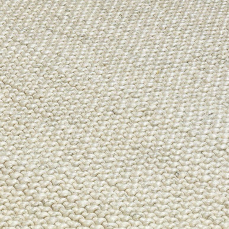 Close up of cream woven wool rug texture