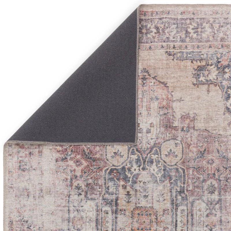 Corner view of vintage pattern area rug with exposed non-slip backing