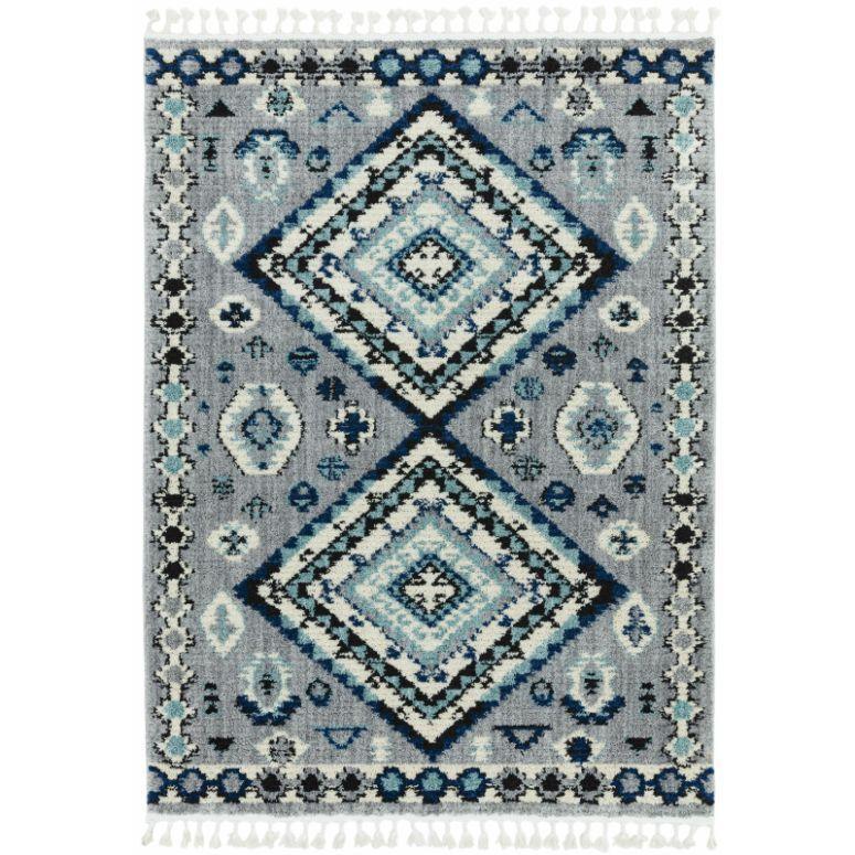 Blue and grey patterned area rug with geometric diamond design and fringe edges