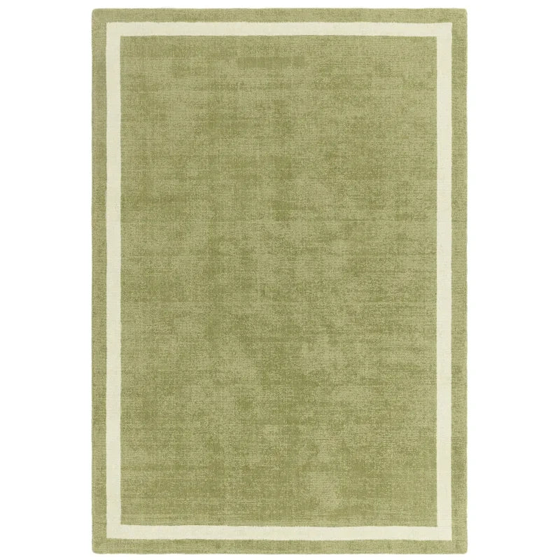 Green rectangular area rug with cream border design, shown from a top-down angle