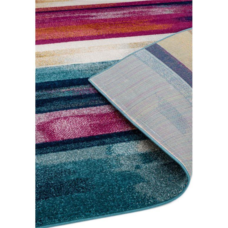 Multicoloured striped rug with folded corner showing backing and vibrant texture detail