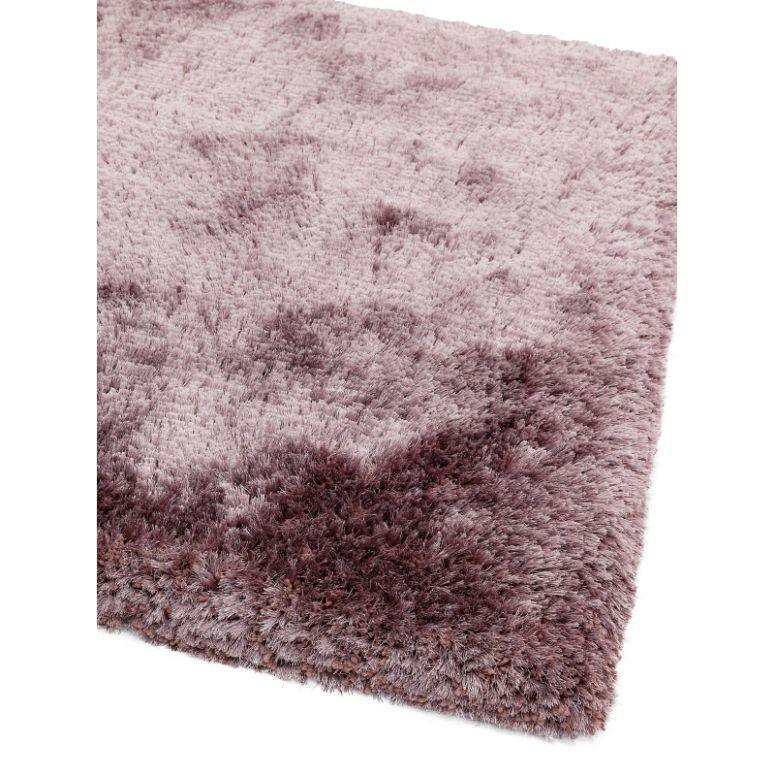 Plush pink shaggy rug corner with soft pile texture