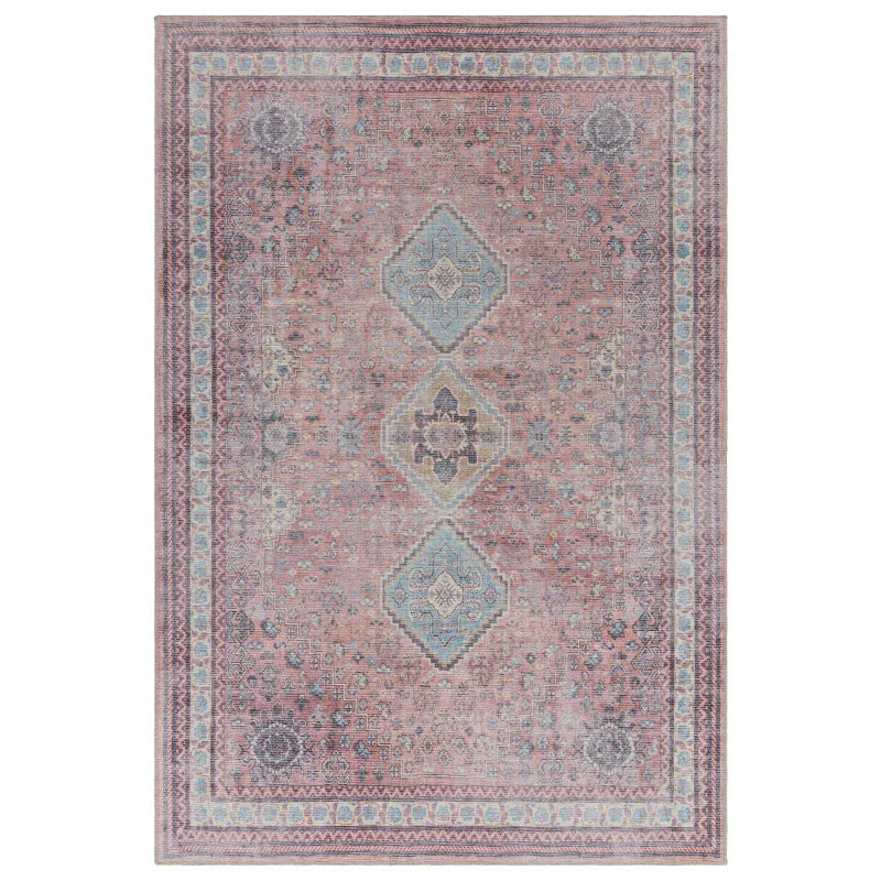 Traditional area rug with pink, blue, and beige geometric medallion and floral border pattern