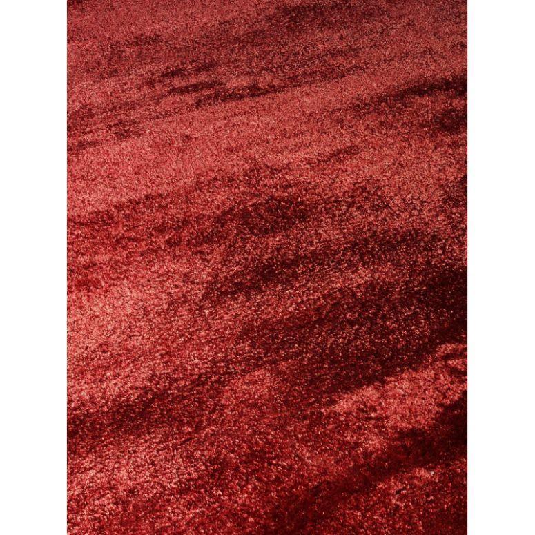 Red velvet rug with soft plush texture and subtle sheen, close-up angled view