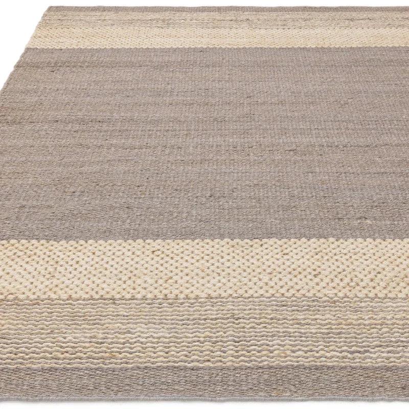 Natural jute rug with beige and cream woven stripes, close-up of texture and pattern