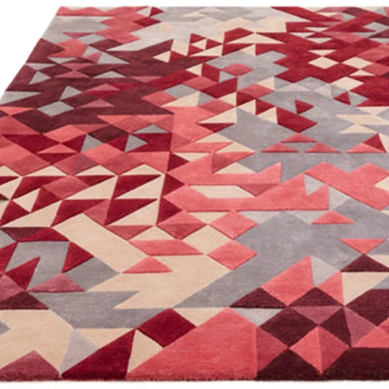 Geometric area rug with red, pink, beige, and grey triangles