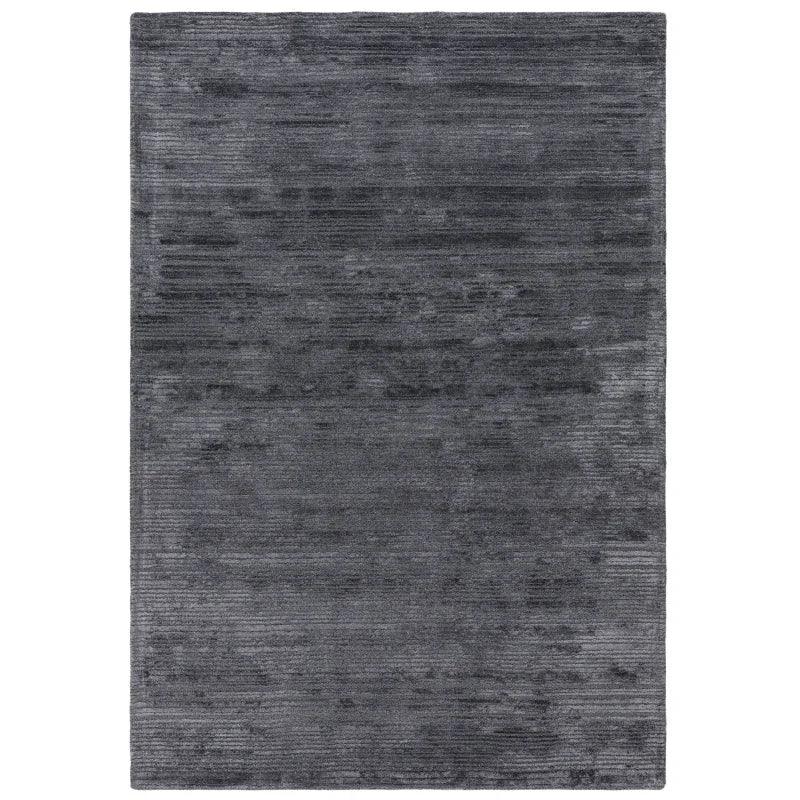 Dark grey textured area rug with subtle linear pattern and soft finish