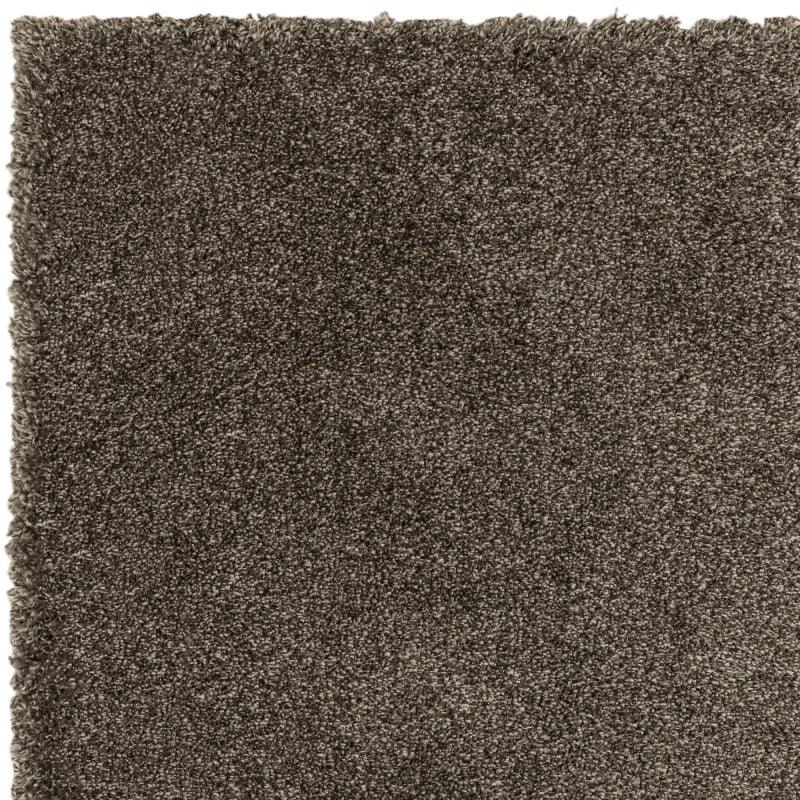 Closeup of brown shaggy rug texture with thick plush pile
