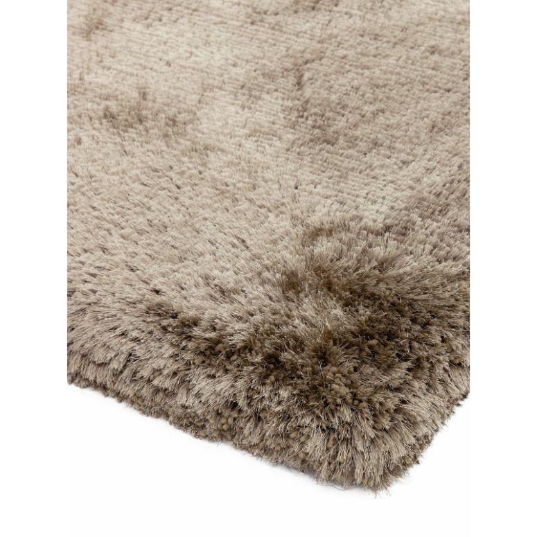 Beige shaggy rug corner with soft, dense pile and textured surface