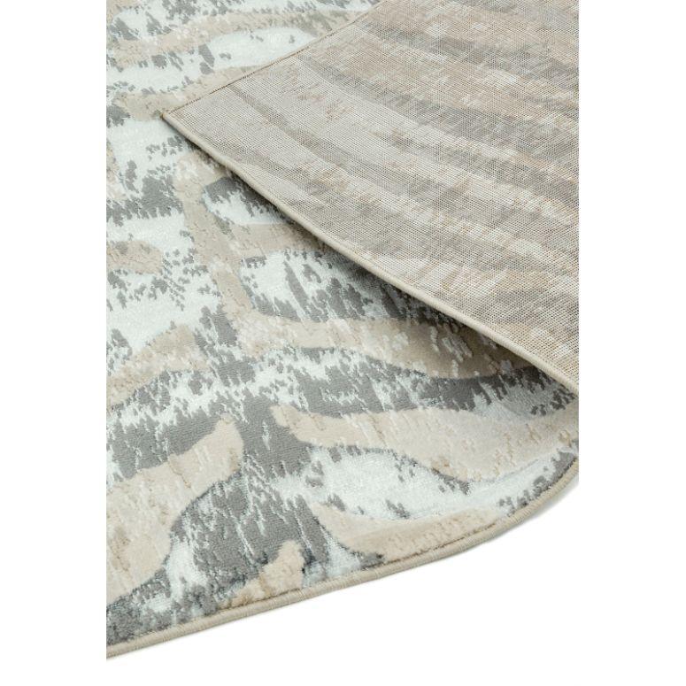 Beige and grey patterned area rug corner showing detailed weave and texture