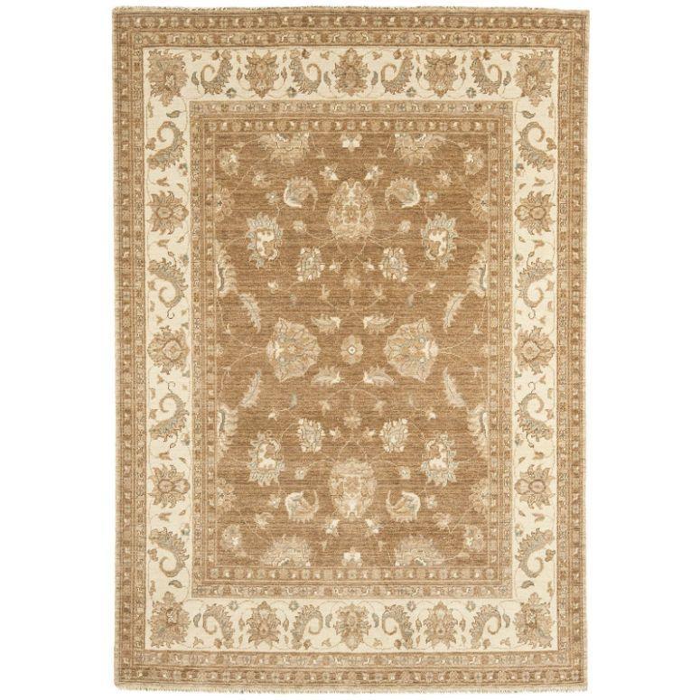 Beige and brown patterned area rug with floral border and traditional design