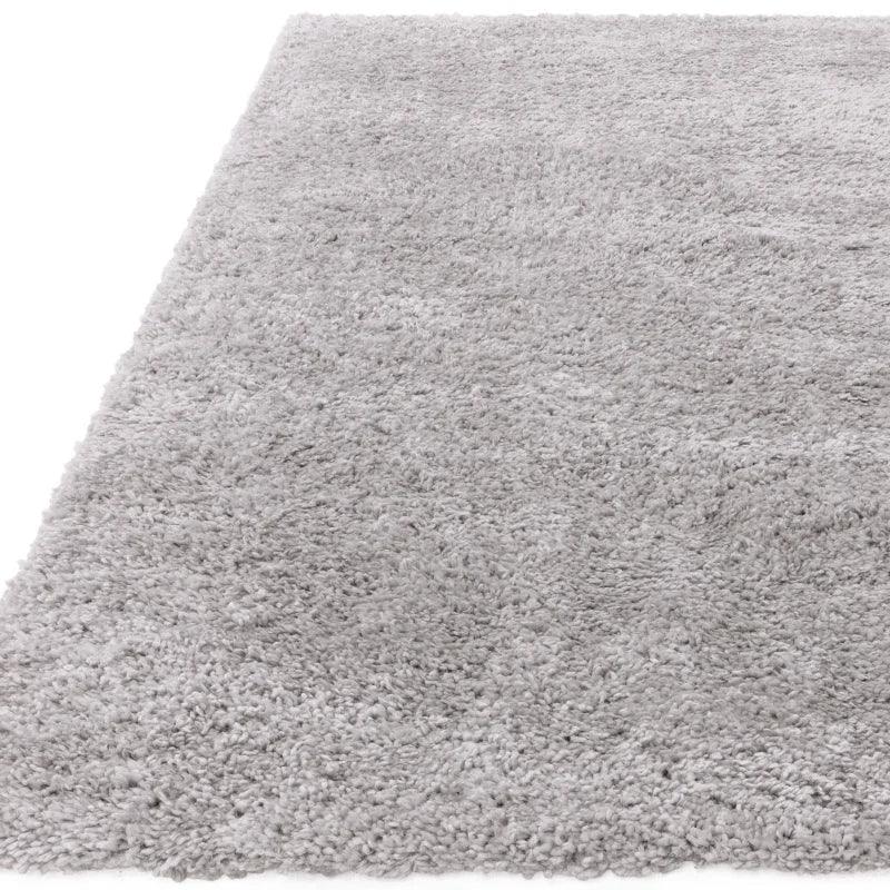 Light grey shaggy rug with thick pile shown from a low angle