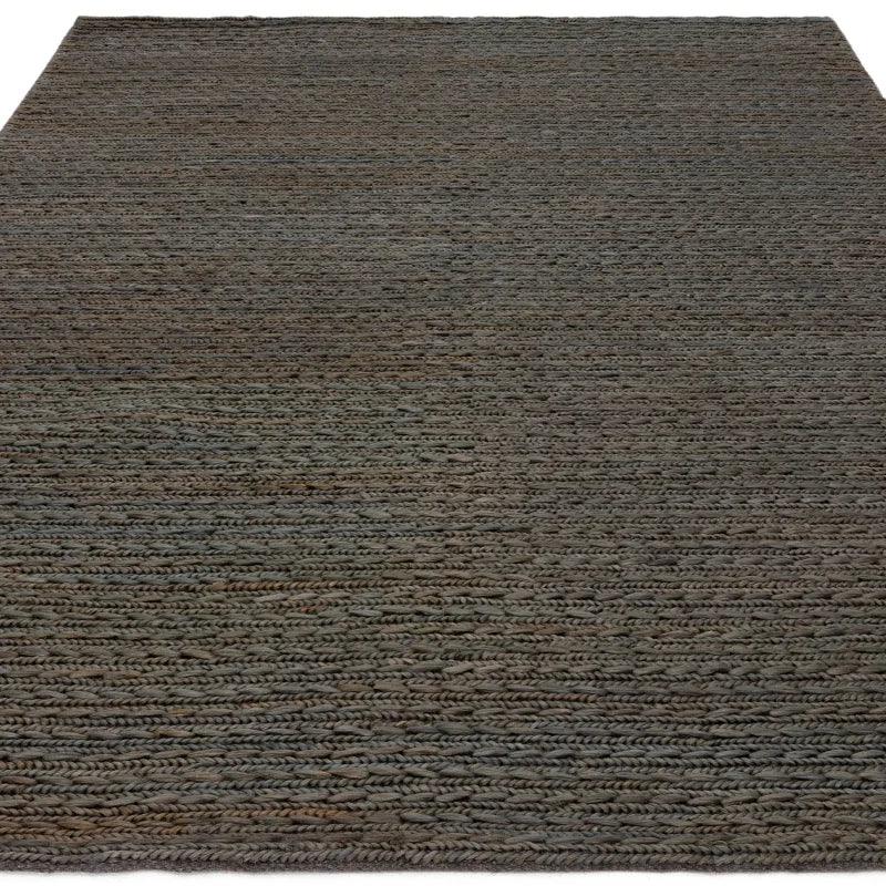 Handwoven grey wool rug with braided texture and rectangular shape