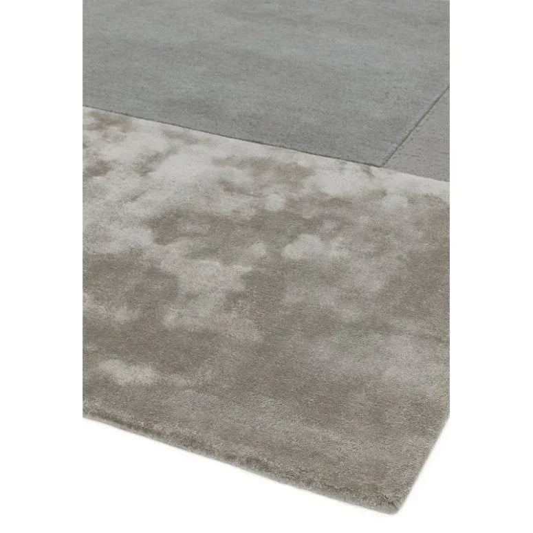 Grey area rug with a two-tone design and soft textured surface