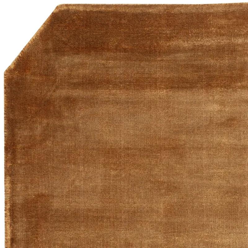 Brown velvet area rug with cut corner and soft pile texture