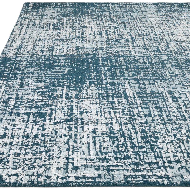 Blue and white abstract pattern area rug with textured modern design