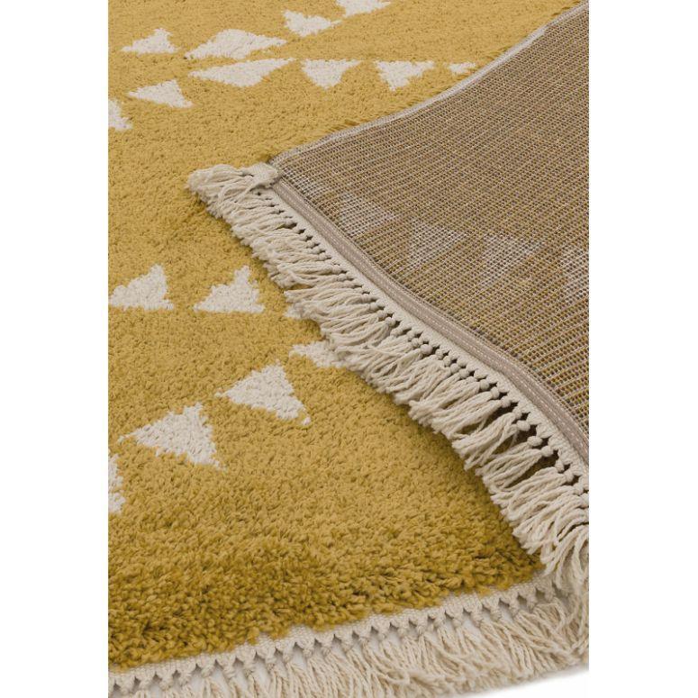Yellow geometric pattern rug with white fringe and corner folded to show backing