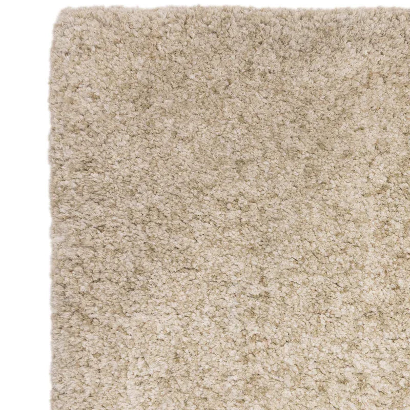 Closeup of beige shaggy rug textured surface and squared corner