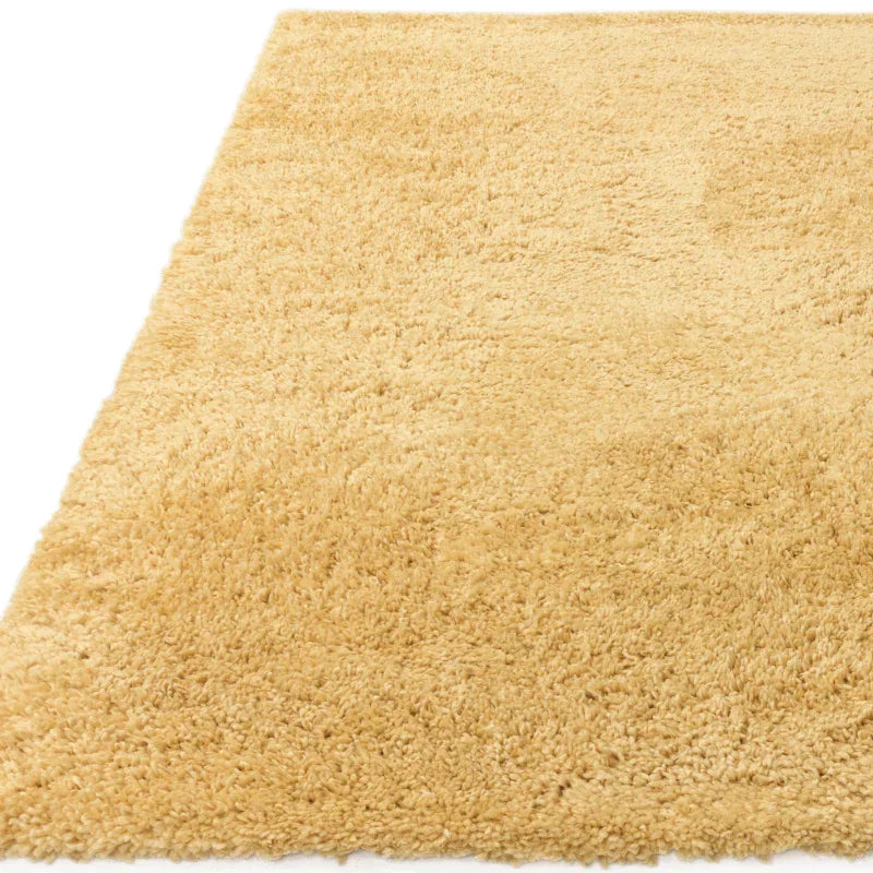 Beige shaggy area rug with soft, thick pile and rectangular shape
