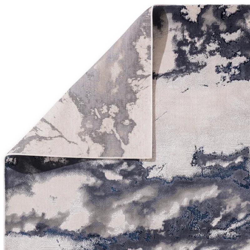 Grey and blue abstract pattern rug corner detail shown with textured weave