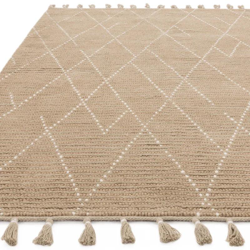 Beige woven rug with white geometric pattern and tassel edging