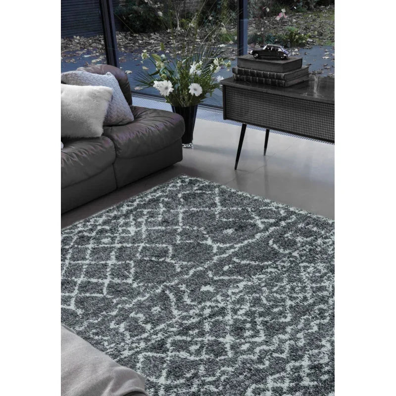 Grey patterned area rug in living room with sofa and sideboard