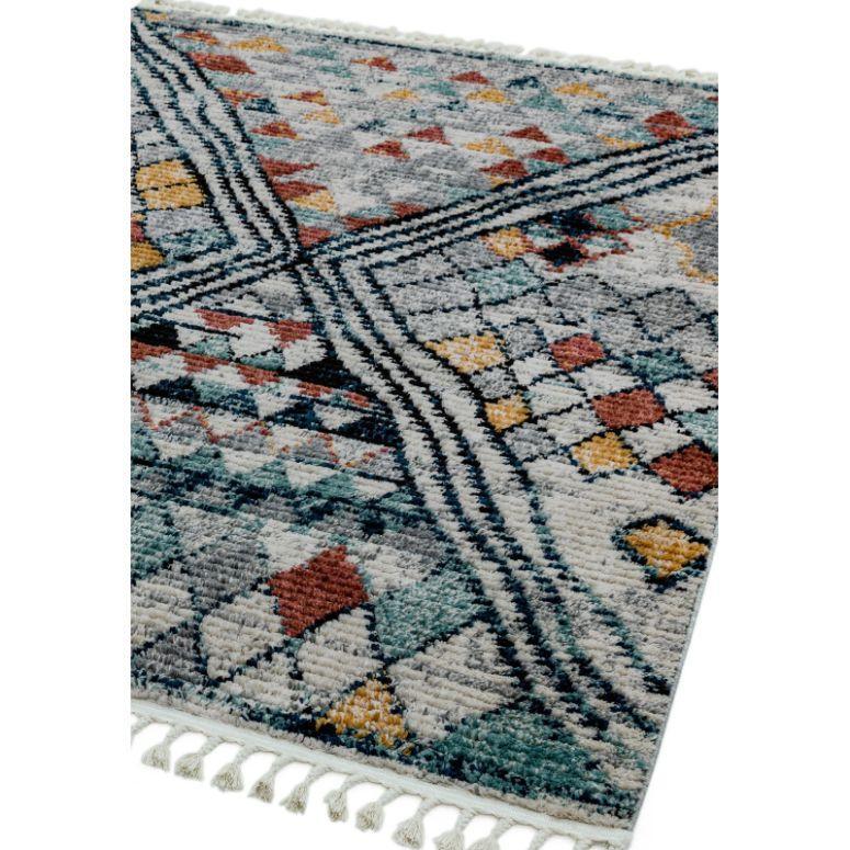 Multi-coloured geometric patterned area rug with tassel fringe on one edge