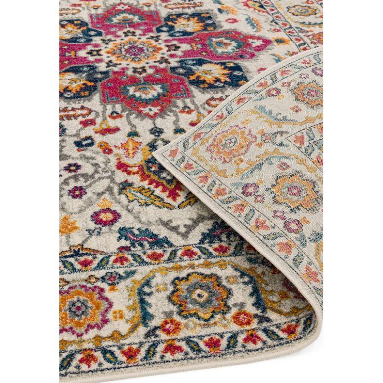 Multicolour patterned area rug with intricate floral design and visible corner fold