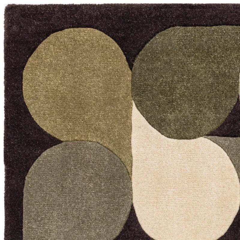 Modern area rug with overlapping beige, sage, and olive geometric shapes