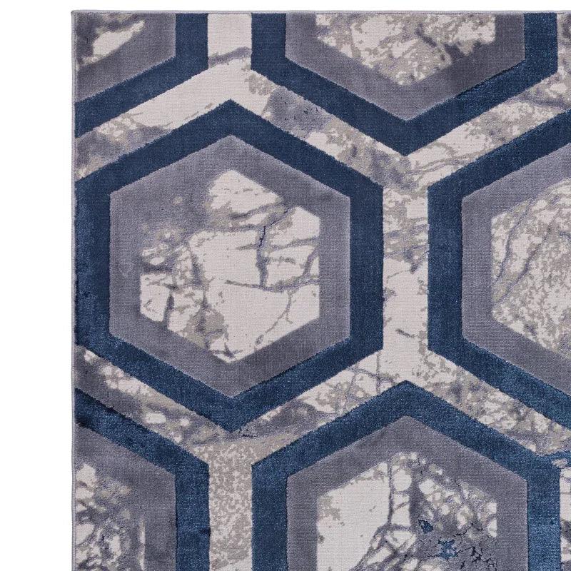 Modern area rug with hexagon geometric pattern in grey and blue tones, close-up view