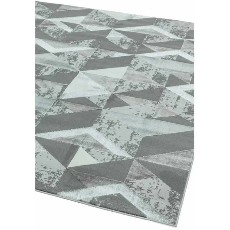 Grey geometric area rug with textured triangles and abstract pattern design