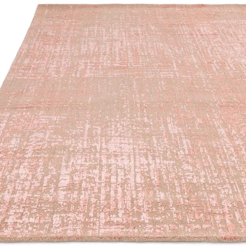 Blush pink patterned area rug with textured finish and soft beige undertones